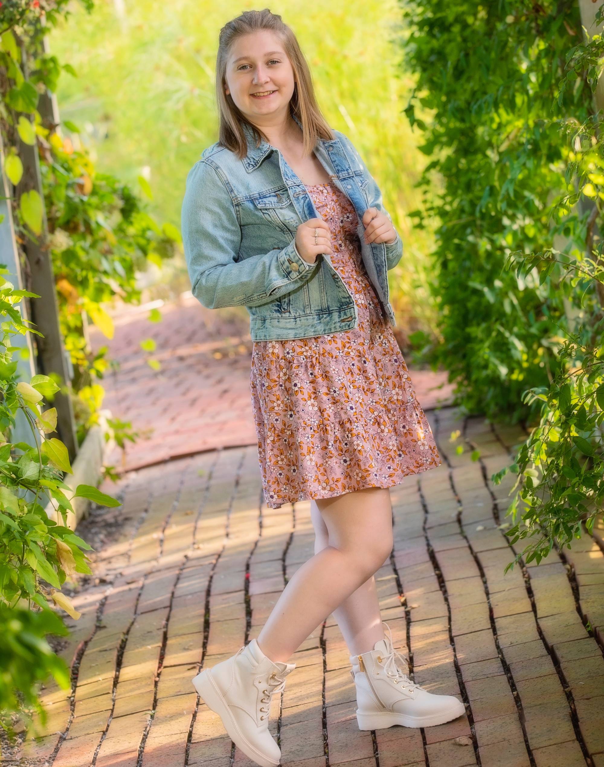 Kaley on a brick pathway during summer